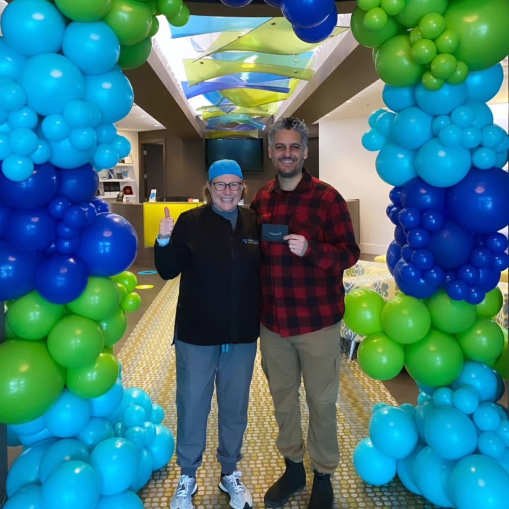 Dr. Lesley Williams stands with a patient at South Surrey Smiles.