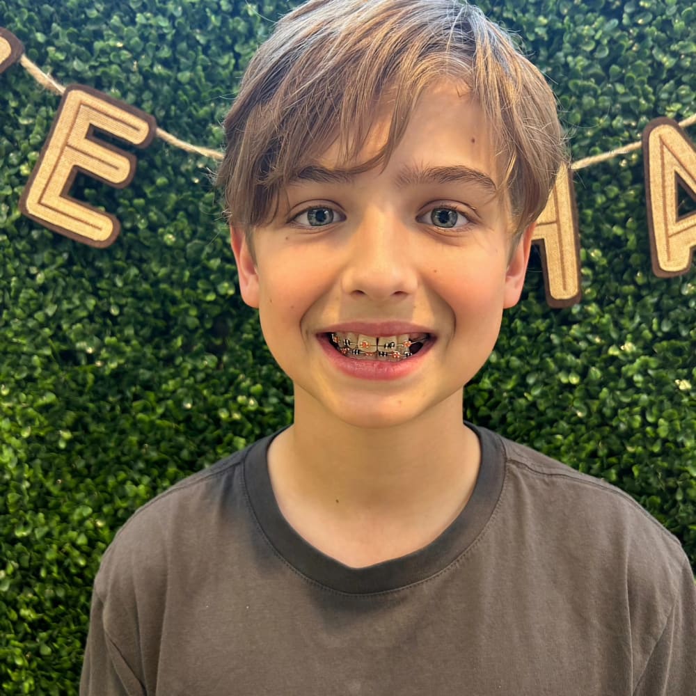 A young boy shows off his braces at South Surrey Smiles.